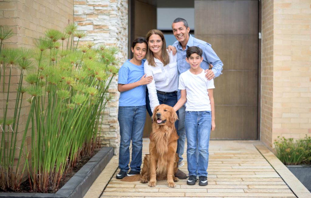 A family with a Golden Retriever, one of the best family dogs 